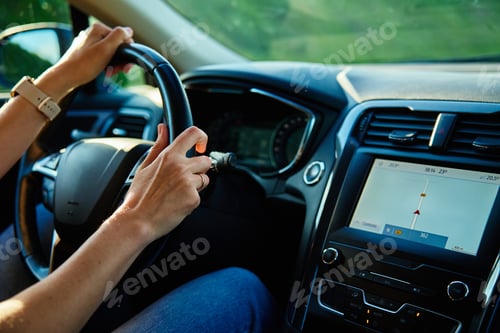 Preview: Inside view of woman driving car on countryside road