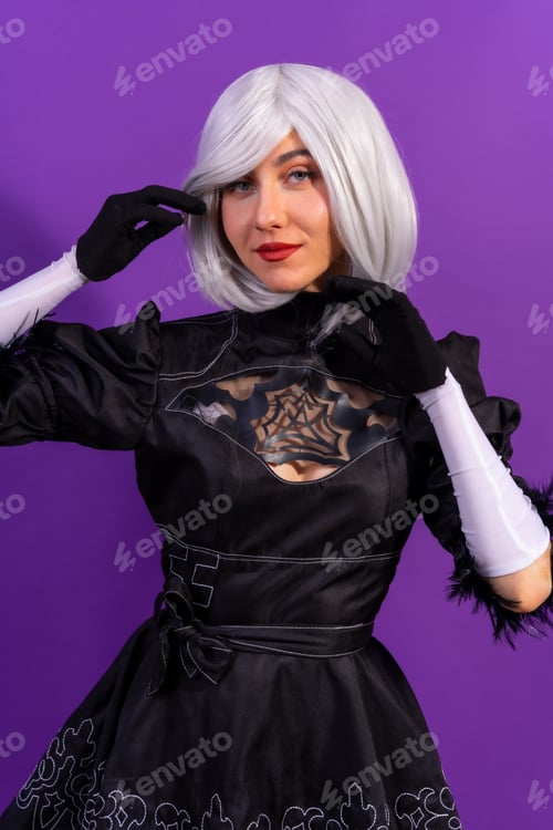Preview: Portrait of cosplay woman in a black costume and a white wig in studio on a purple background