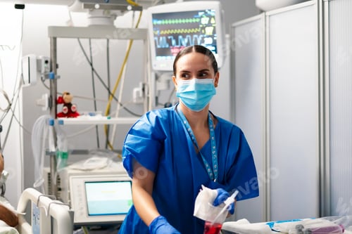 Preview: Nurse working in intensive care unit with patient monitoring