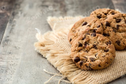 Preview: Chocolate chip cookies resting on rustic burlap on wooden table