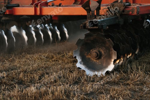 Preview: A tractor with a large disc harrow for tillage. Farmer work concept.
