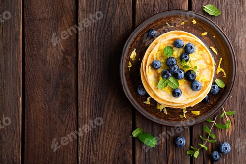 Vista previa: Pancakes with fresh blueberry on wooden rustic background. Top view
