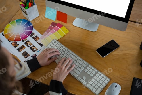 Preview: Female graphic designer working at desk
