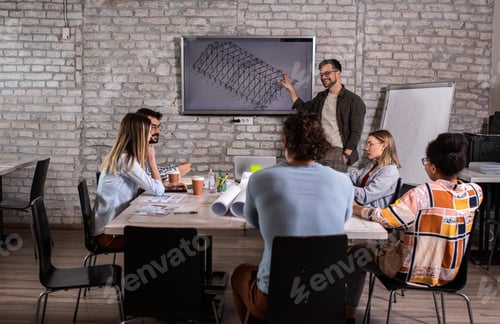 Preview: Group of modern business people discussing architectural designs in the creative office.