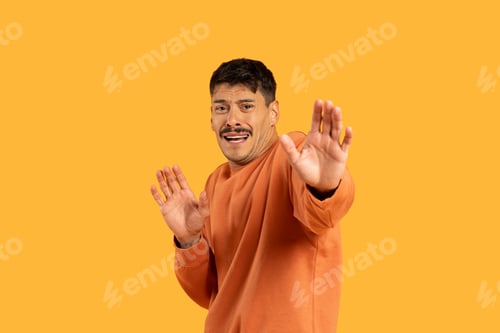 Preview: Man Standing in Front of Yellow Background