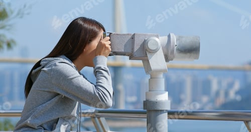 Preview: Tourist look at the binocular for seeing the view in Hong Kong