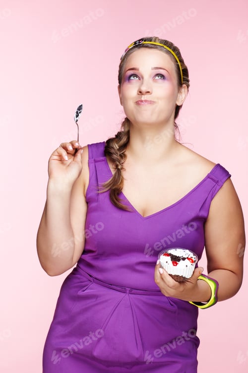 Preview: Portrait Of Beautiful Plus Size Curly Young Blond Woman Posing On Pink With Sweet Pastry