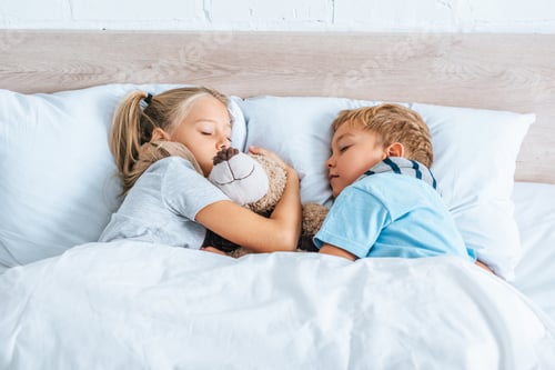 Preview: diseased brother and sister sleeping in bed with teddy bear
