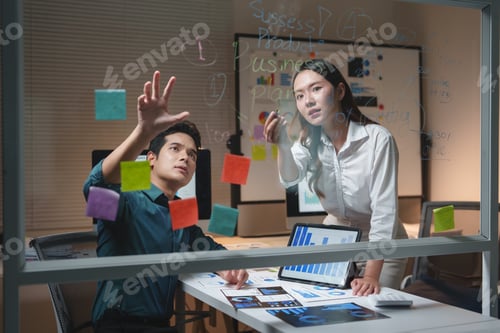 Preview: Business colleagues collaborating on strategy plan in office