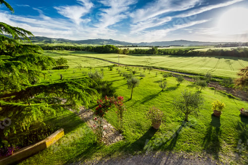 Preview: Sunset over the green valley in Tuscany