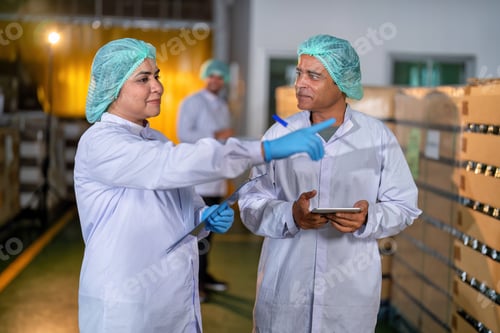 Preview: In warehouse quality control team checking drinking bottle stack on pallet before delivery