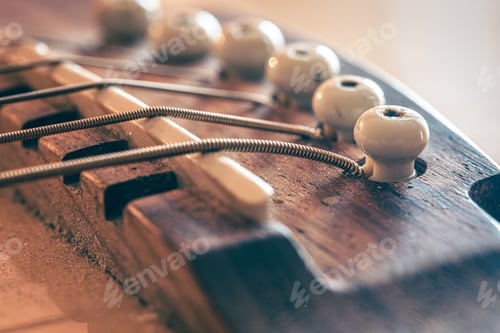 Preview: Acoustic guitar bridge and strings close up.