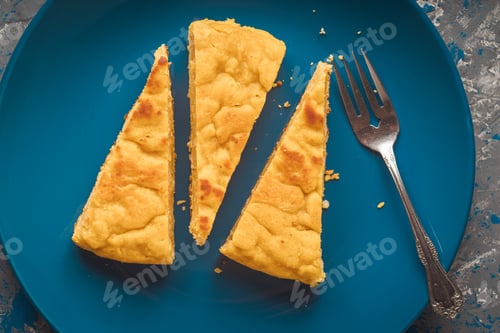 Preview: Portions of pumpkin pie on a blue plate accompanied by a fork