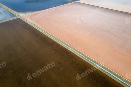 Preview: Aerial drone photo of colourful salt flats textures in Phetchaburi, Thailand