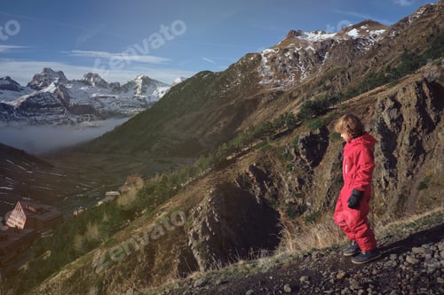 Preview: Boy walking on slope of mountain