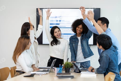 Preview: business team celebrates corporate victory together in the office, happy overjoyed professionals gro