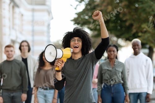 Preview: Enthusiastic mixed race man with loudspeaker leading strike