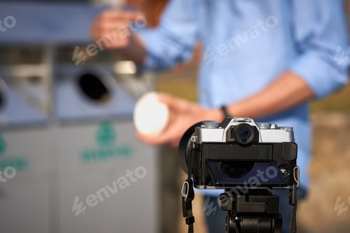 Preview: Man throwing paper coffee cup in waste sorting bin of the park