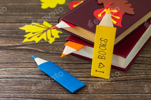 Preview: Multicolored bookmarks origami pencil made of paper with the inscription that I love a book.