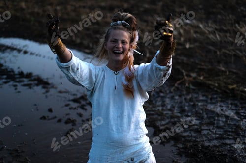 Preview: Happy woman with dirty black hands on a muddy field, joyful emotions in monochrome