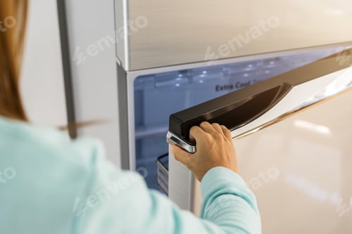 Preview: young woman hand opening refrigerator door