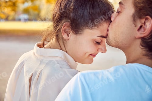 Preview: Young couple in love kissing outdoors