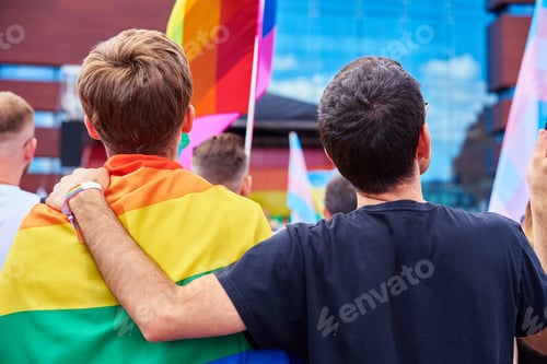 Preview: Gay couple with LGBTQ rainbow flags on pride demonstration