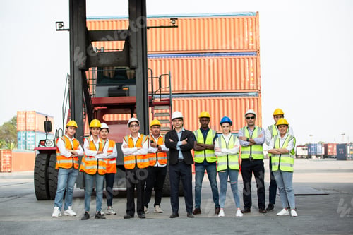 Preview: Successful logistic worker team standing at container warehouse