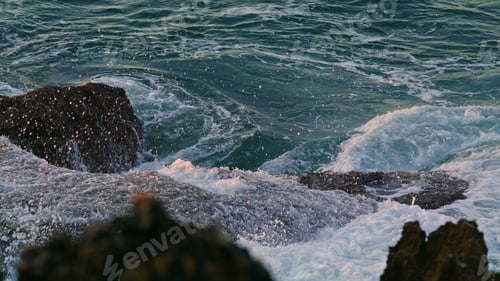 Preview: Churning sea washing crag dusk environment closeup. Swirling aqua hitting shore