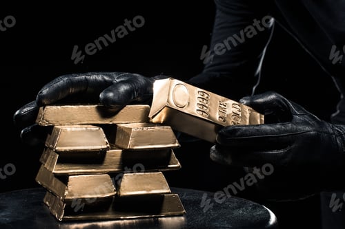 Preview: Close-up view of golden bars in hands of thief