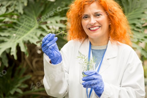 Preview: Biologist looking at the camera collecting samples from a greenhouse