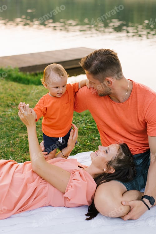 Preview: Loving Family Enjoying Time Together Outdoors on Blanket