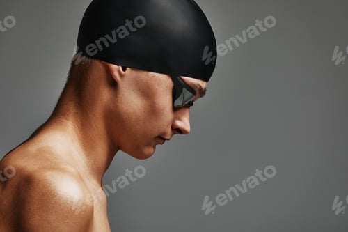 Preview: Face of a man swimmer close-up, gray background, copy space, young guy swimmer in a mask and