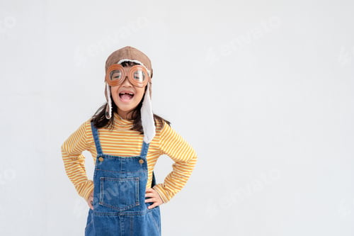 Preview: A little child girl in an astronaut costume is playing and dreaming of becoming a spaceman.