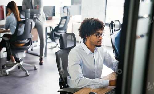 Preview: Office with business people working on computers