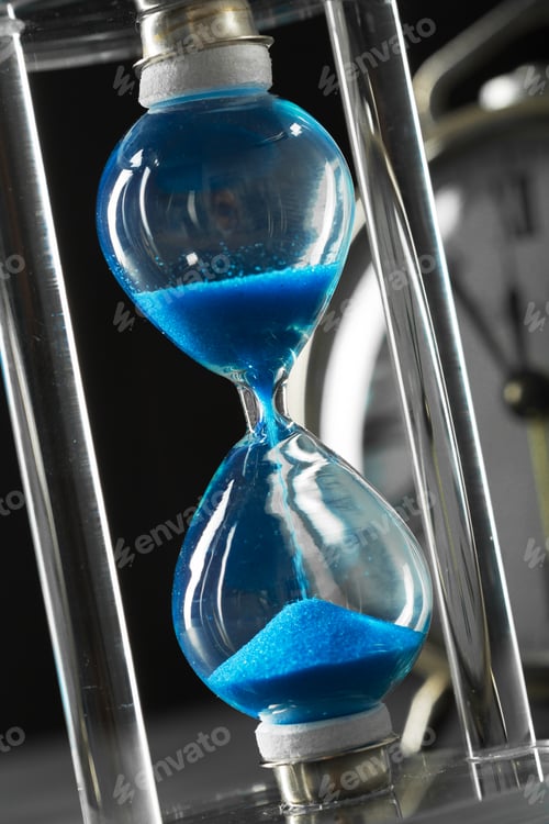 Preview: Time is passing. Blue hourglass close up