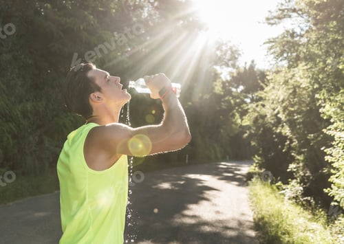 Preview: Jogger in the park drinking water