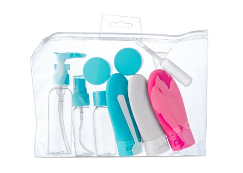 Preview: Travel toiletry kit with various-sized bottles and containers in a clear zip bag
