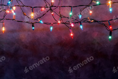 Preview: Christmas lights string on loft wall background with copy space