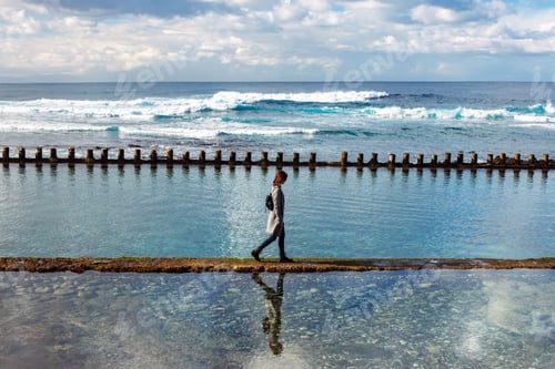 Preview: Lonely woman walking on ocean beach