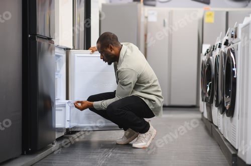Preview: Customer inspecting refrigerator in electronics store