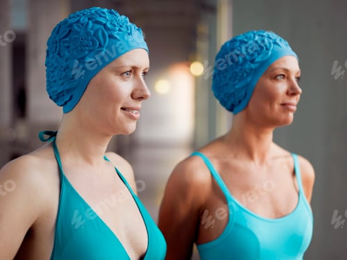 Preview: Two women wearing swimming caps
