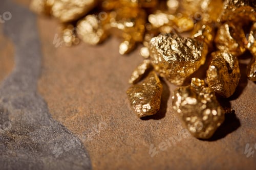 Preview: selective focus of golden stones on brown marble background