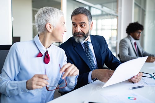 Preview: Portrait of happy business people discussing together in office
