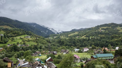 Preview: Mountain village in Carpathians after the rain with steaming slopes