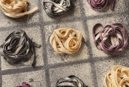 Preview: Colorful tagliatelli nests on black background