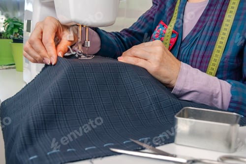 Preview: Seamstress hands working on a sewing machine