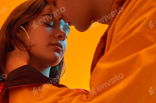 Preview: Teenager kissing girlfriend in neon light