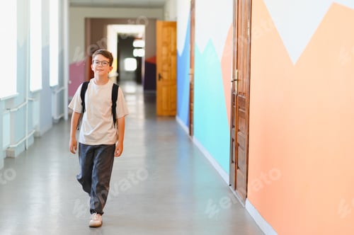 Preview: Smiling pupil walking in school hallway during break time