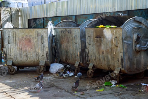 Preview: Dumpsters being full with garbage in a city. Dumpsters being full with garbage